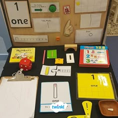 a table topped with lots of different types of paper and magnets on top of it