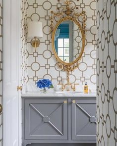 a bathroom vanity with a mirror and blue flowers