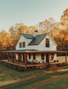 a large white house sitting on top of a lush green field