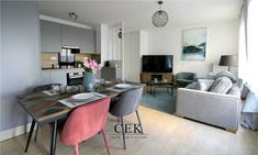 a living room filled with furniture and a flat screen tv sitting on top of a wooden table