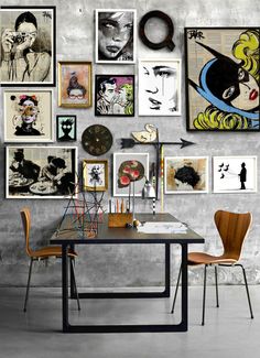 a table with some chairs and pictures on the wall