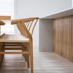 two wooden chairs sitting next to each other on top of a hard wood floor