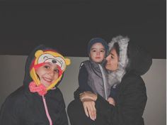 two women and a child in costumes are posing for a photo with their faces painted to look like cartoon characters