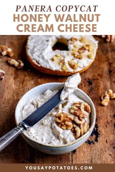 a bowl filled with cream cheese and walnuts next to a bagel covered in nuts