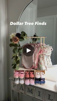 a baby's clothing rack with shoes and flowers on it