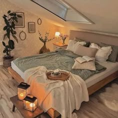 a bed with pillows and blankets on top of it in a room that has wooden floors