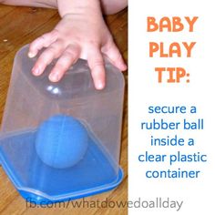 a baby playing with a rubber ball inside a clear plastic container