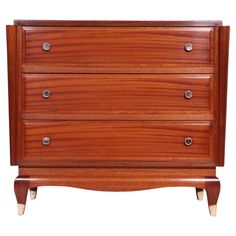 a wooden dresser with three drawers on it