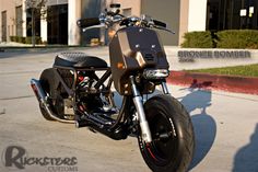 a black motorcycle parked in front of a building