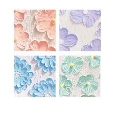 four different colored paper flowers on a white background