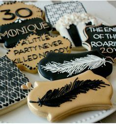 decorated cookies with black and white designs are on a platter for someone's 30th birthday