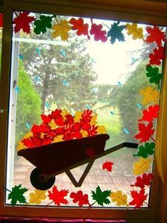 a wheelbarrow made out of leaves on a window sill