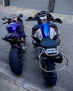 two motorcycles parked next to each other on the street