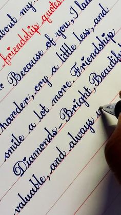 a person writing on a piece of paper with a fountain pen in their left hand