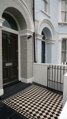 a black and white checkered floor in front of a house