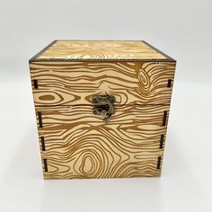 a wooden box that is sitting on a white surface with woodgrains in it