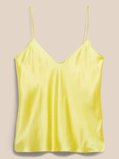 An indulgent, elegant essential, this versatile camisole is crafted from our washable silk charmeuse and cut on the bias for figure-flattering drape.  SEMI-FITTED: Cut for a not-too-tight, not-too-loose fit.  V-neck.  Adjustable slider straps.  Dolph Silk Cami Tank Top With Built-in Bra, Silk Cami Top With Built-in Bra, Elegant Solid Color Cami Tank Top, Silk Camisole With Built-in Bra, Summer Silk Tank Top With Built-in Bra, Silk Tank Top With Built-in Bra For Spring, Silk Camisole With Built-in Bra And Spaghetti Straps, Sleek Silk V-neck Camisole, Sleek Satin V-neck Camisole