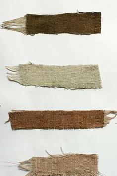 four pieces of cloth with fringes on them