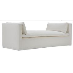 a white couch sitting on top of a white floor