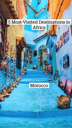 an alley way with blue walls and pictures on the wall