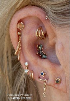 an ear with different types of piercings on it