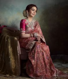 Mukesh and Nita Ambani hosted one of the most extravagant weddings the world has ever seen for their youngest son, Anant Ambani. The latter got married to Radhika Merchant on July 12, 2024, after courting her for around six years. Their wedding was covered extensively all around the world, as several renowned names from all walks of life were present at the soiree. However, what caught the most attention was the opulent sartorial picks of the Ambani ladies.
 
 Nita Ambani once again r... Dolly Jain, Radhika Merchant, Anant Ambani, Nita Ambani, Golden Saree, Brocade Saree, Valentino Gowns, Extravagant Wedding, Saree Gown