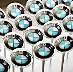 many bmw emblems are displayed on sticks