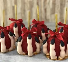 chocolate covered desserts with red and white icing on gold plated serving utensils