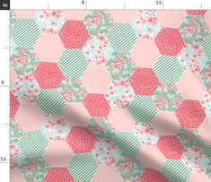 a pink and green flowered fabric with hexagonals on it, as well as