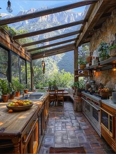 an outdoor kitchen with stone walls and flooring, surrounded by greenery in the mountains