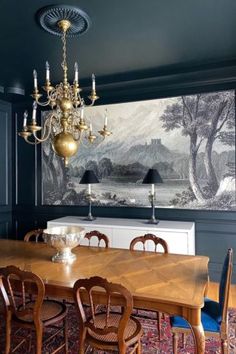 a dining room table with chairs and a chandelier hanging from it's ceiling