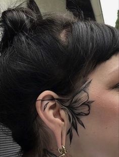 a woman with tattoos on her face and ear