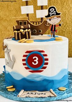 a birthday cake decorated with a pirate ship and the number three on it's side