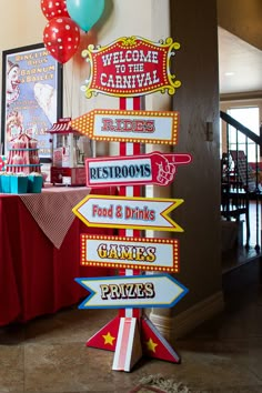 there are many signs on the table at this carnival themed birthday party that say welcome to the carnival