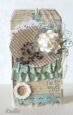 a close up of a small card with flowers and laces on the edge,