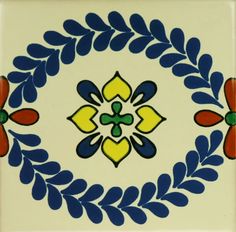 a blue and yellow floral design on a white tile