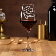 a wine glass sitting on top of a wooden table