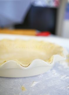 an uncooked pie crust sitting on top of a table