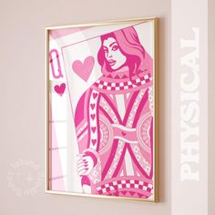 a pink and white art piece hanging on the wall next to a window with an image of a woman holding a card