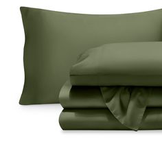 the sheets and pillowcases are made up in dark green color, with two pillows on each side