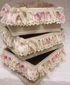 four pieces of lace are stacked on top of each other, with pink and white flowers