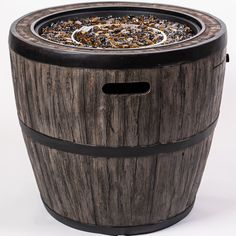 an old wooden barrel is filled with seaweed