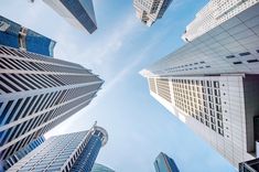 looking up at tall buildings in the city