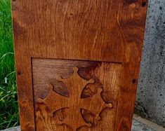 a wooden box sitting on top of a cement slab