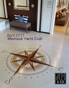 a white floor with a compass on it and the words montauk yacht club