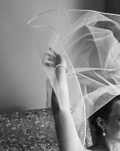 black and white photograph of woman with veil over head