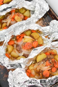 three foil packets filled with meat, potatoes and carrots