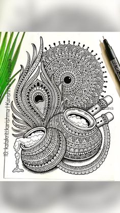 an intricately designed drawing on paper next to some green plants and pencils with markers