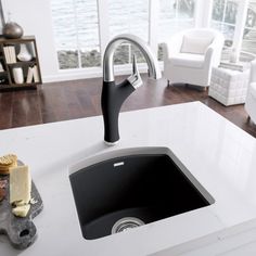 a kitchen sink sitting on top of a white counter