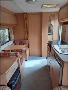 the inside of a camper with kitchen and living room area in it's center